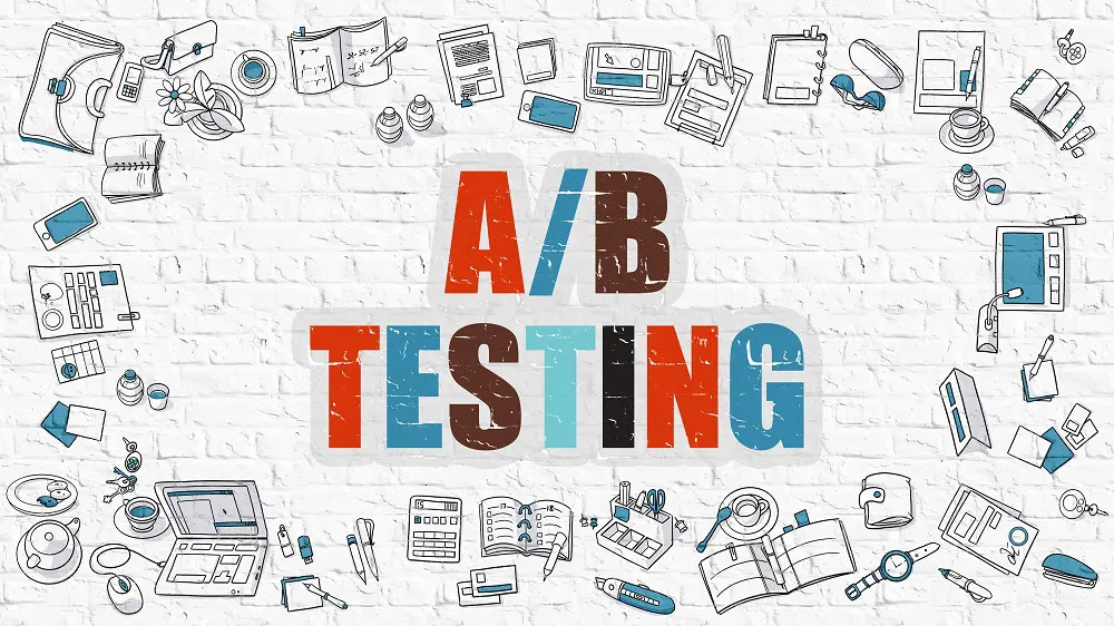 Multicolored grunge lettering reading "A/B Testing" on a white brick wall, ringed by hand-drawn office and device doodles