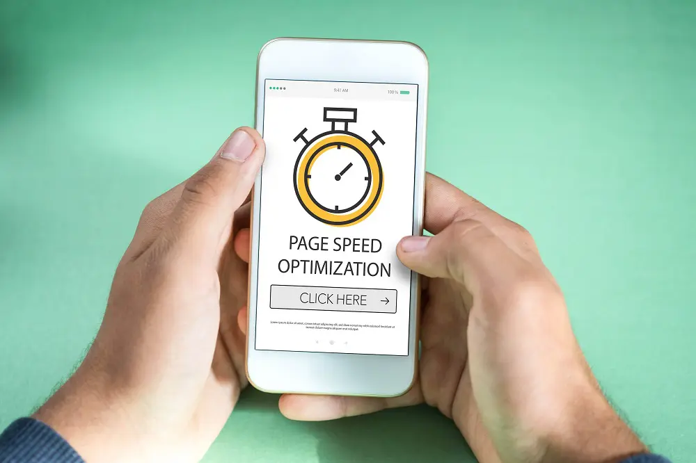 Two hands holding a white smartphone whose screen shows a stopwatch icon above the words "Page Speed Optimization" and a "Click Here" button