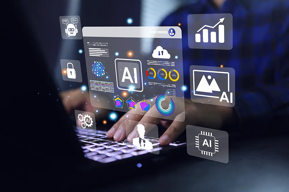 Hands typing on a laptop surrounded by floating translucent panels of AI icons, charts and a browser window in a dark office